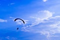 Paramotor silhouette in blue sky