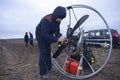 Paramotoring. Instructor helping the paramotorist to prepare equipment for flight