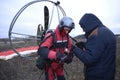 Paramotoring. Instructor helping the paramotorist to prepare equipment for flight