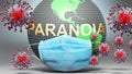 Paranoia and covid - Earth globe protected with a blue mask against attacking corona viruses to show the relation between Paranoia