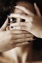 Paranoid about her appearance. Closeup portrait of a young woman covering her mouth and face with her hands. Royalty Free Stock Photo