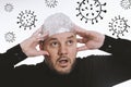 Paranoid man wearing tin foil hat against corona virus covid-19 Royalty Free Stock Photo