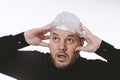 paranoid man wearing tin foil hat