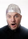 Paranoid man wearing tin foil hat in shock Royalty Free Stock Photo
