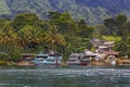 Berth for pleasure boats and ferries on Lake Toba against a background of tropical trees and Royalty Free Stock Photo
