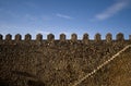 Parapet walk of a fortress. Stairway and merlons.