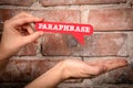 Paraphrase. Red speech bubble with text on a red brick background Royalty Free Stock Photo