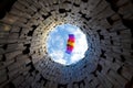 Paraplane in a blue sky. Bottom view through wood tower Royalty Free Stock Photo