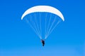 A paraplane flying high up in the deep blue sky Royalty Free Stock Photo