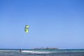 Paraplane flying near the waters on background of an empty sky