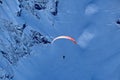 Paraplane flying over snowy Caucasus mountains sunny blue sky