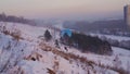 The paraplaner jumps with a running start and takes off over the snowy slope