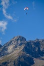 Paraplaners in tandem gliding in blue sky and Alpine mountains on paraplane Royalty Free Stock Photo