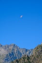 Paraplaners in tandem gliding in blue sky and Alpine mountains on paraplane Royalty Free Stock Photo
