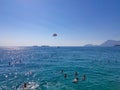 Parasailing in a blue sky near sea beach. Parasailing is a popular recreational activity among tourists in Turkey. For