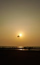 Parasailing extreme sports on beach in sunset background. Royalty Free Stock Photo