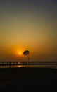 Parasailing extreme sports on beach in sunset background. Royalty Free Stock Photo