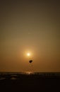 Parasailing extreme sports on beach in sunset background. Royalty Free Stock Photo