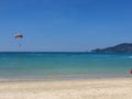 Parasailing over clear blue waters. Different shades of blue in the water