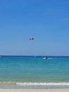 Parasailing over clear blue waters. Different shades of blue in the water Royalty Free Stock Photo