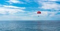 Parasailing is a popular form of outdoor activity at sea. Flight on a parachute behind a boat on the sea. Beautiful seascape.