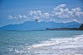 Parasailing on the waves of the azure Andaman sea under the blue sky near the shores of the sandy beautiful exotic and stunning Royalty Free Stock Photo