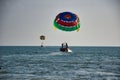 Parasailing on the waves of the azure Andaman sea under the blue sky near the shores of the sandy beautiful exotic and stunning Royalty Free Stock Photo