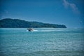 Parasailing on the waves of the azure Andaman sea under the blue sky near the shores of the sandy beautiful exotic and stunning Royalty Free Stock Photo