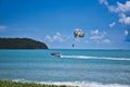 Parasailing on the waves of the azure Andaman sea under the blue sky near the shores of the sandy beautiful exotic and stunning Royalty Free Stock Photo