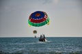 Parasailing on the waves of the azure Andaman sea under the blue sky near the shores of the sandy beautiful exotic and stunning Royalty Free Stock Photo