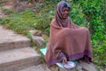 PARASHNATH, JHARKHAND, INDIA- JANUARY 25 2017: Street portrait of a lady indian beggar who is sitting on the side of a street and Royalty Free Stock Photo