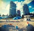 Parasols and beach toys with skyscrapers on the background