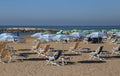 parasols and deck chairs in the sun-drenched beach in summer