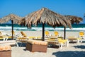 Parasols with deckchairs on the beach Royalty Free Stock Photo