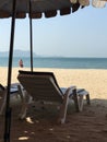 Parasols and sun loungers on the sandy beach Royalty Free Stock Photo