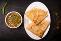 paratha with dal chana or chanay served in dish isolated on dark background top view indian spices, bangladeshi and pakistani food