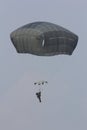 A paratrooper coming down on a parachute Royalty Free Stock Photo