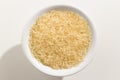 Parboiled Chinese Rice seed. Top view of grains in a bowl. White Royalty Free Stock Photo