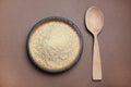 Parboiled rice in wooden bowl and spoon on color background Royalty Free Stock Photo