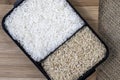 Parboiled white rice and integral rice on the wooden table Royalty Free Stock Photo