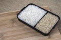 Parboiled white rice and integral rice on the wooden table Royalty Free Stock Photo