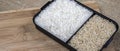 Parboiled white rice and integral rice on the wooden table Royalty Free Stock Photo