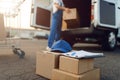 Parcel boxes and cap, deliveryman on background Royalty Free Stock Photo