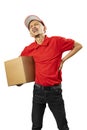 A parcel delivery man with a hat feels back pain while carrying a package Royalty Free Stock Photo