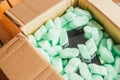 Parcel of online shop, phone in a cardboard box on green styrofoam Royalty Free Stock Photo