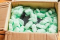 Parcel of online shop, phone in a cardboard box on green styrofoam Royalty Free Stock Photo