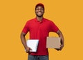 African american delivery man holding clipboard and box Royalty Free Stock Photo