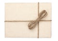 Parcel wrapped, gift box with brown kraft paper and tied with twine and bow. Isolated on white background, top view, close-up Royalty Free Stock Photo