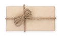 Parcel wrapped, gift box with brown kraft paper and tied with twine and bow. Isolated on white background, top view, close-up Royalty Free Stock Photo