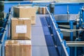 Parcels on conveyors with blurred industrial background Royalty Free Stock Photo